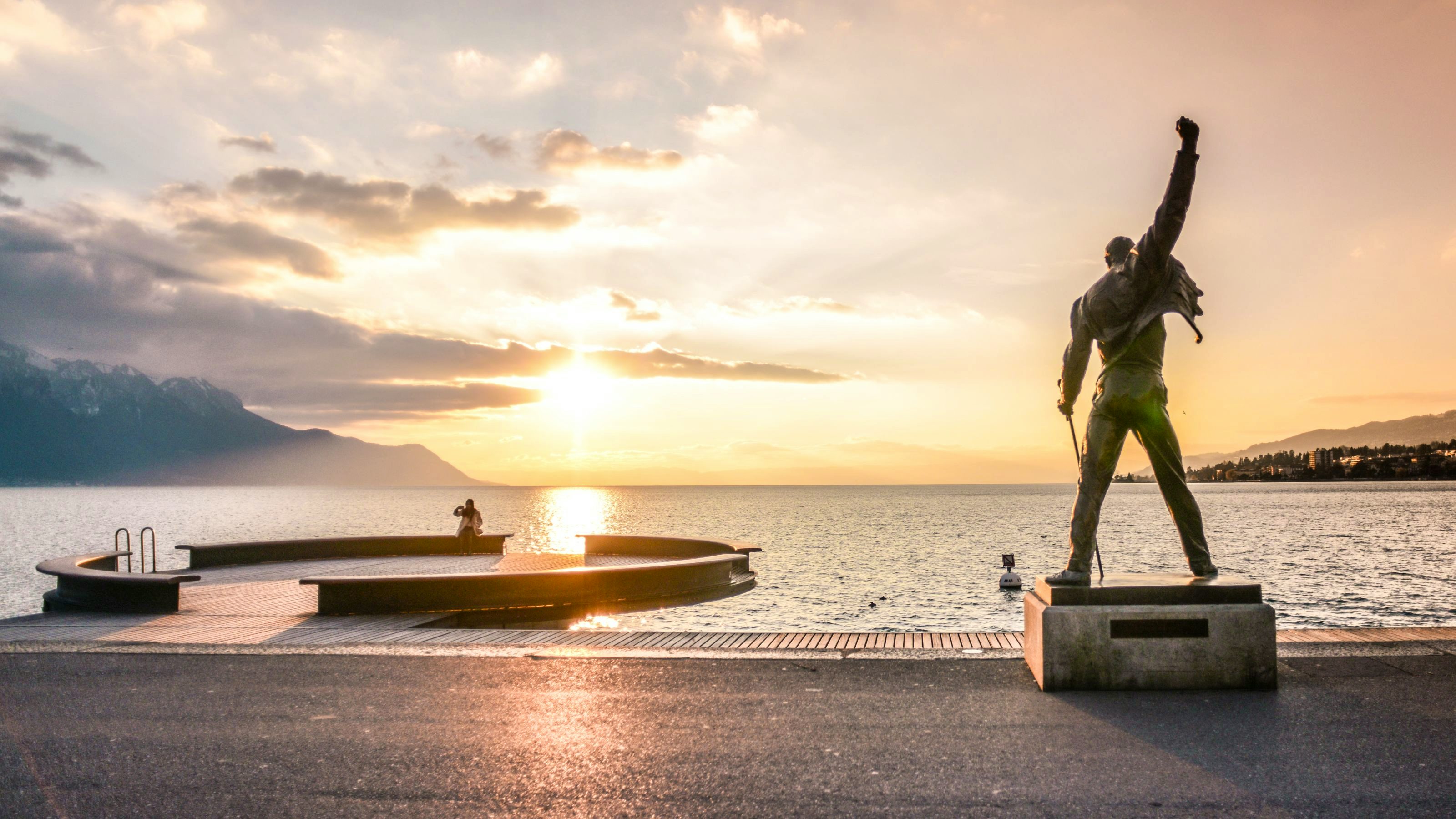 A sunset view of the lake from behind the Freddie Mercury statue.