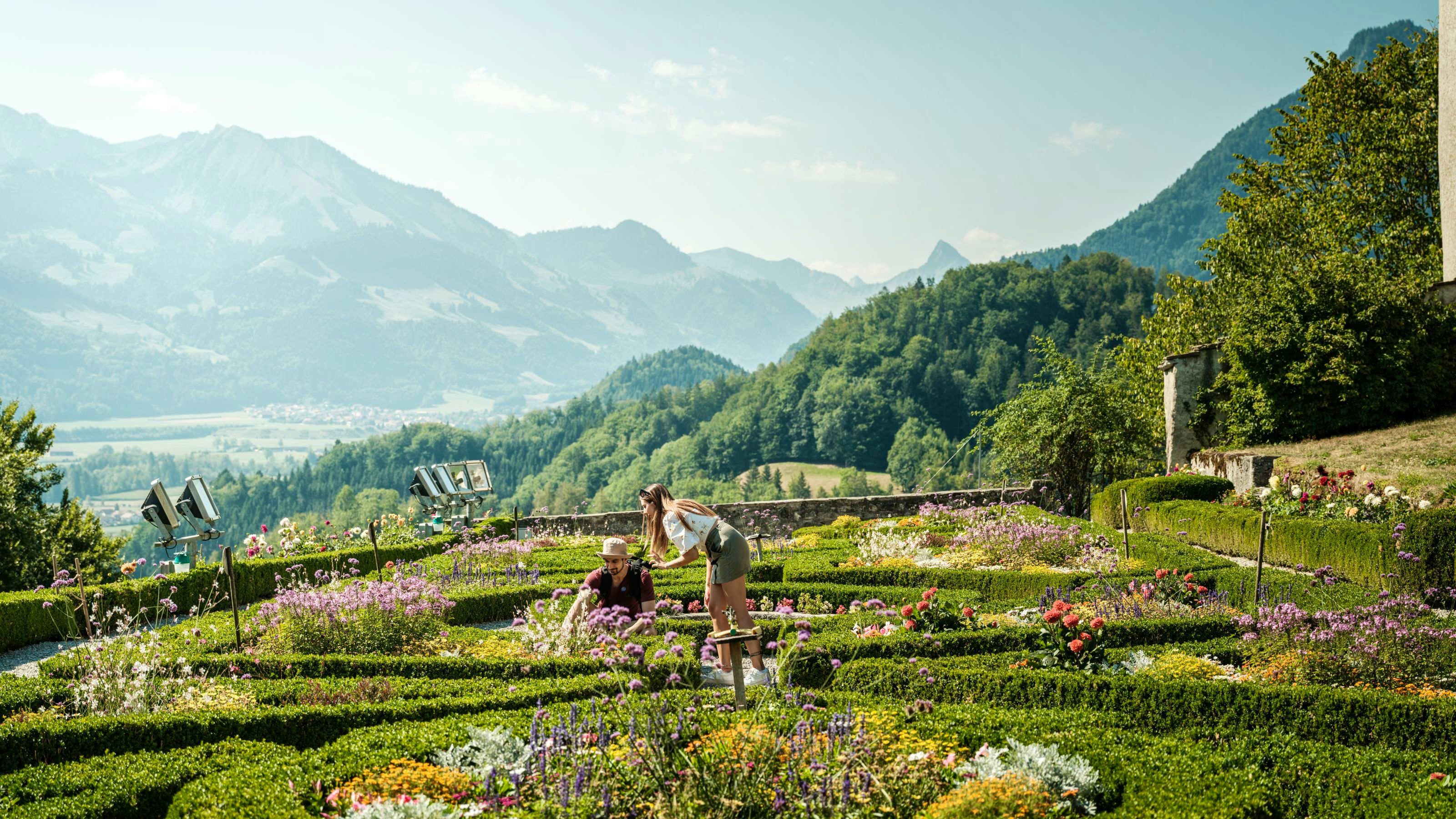 Two people in a castle garden in bloom.