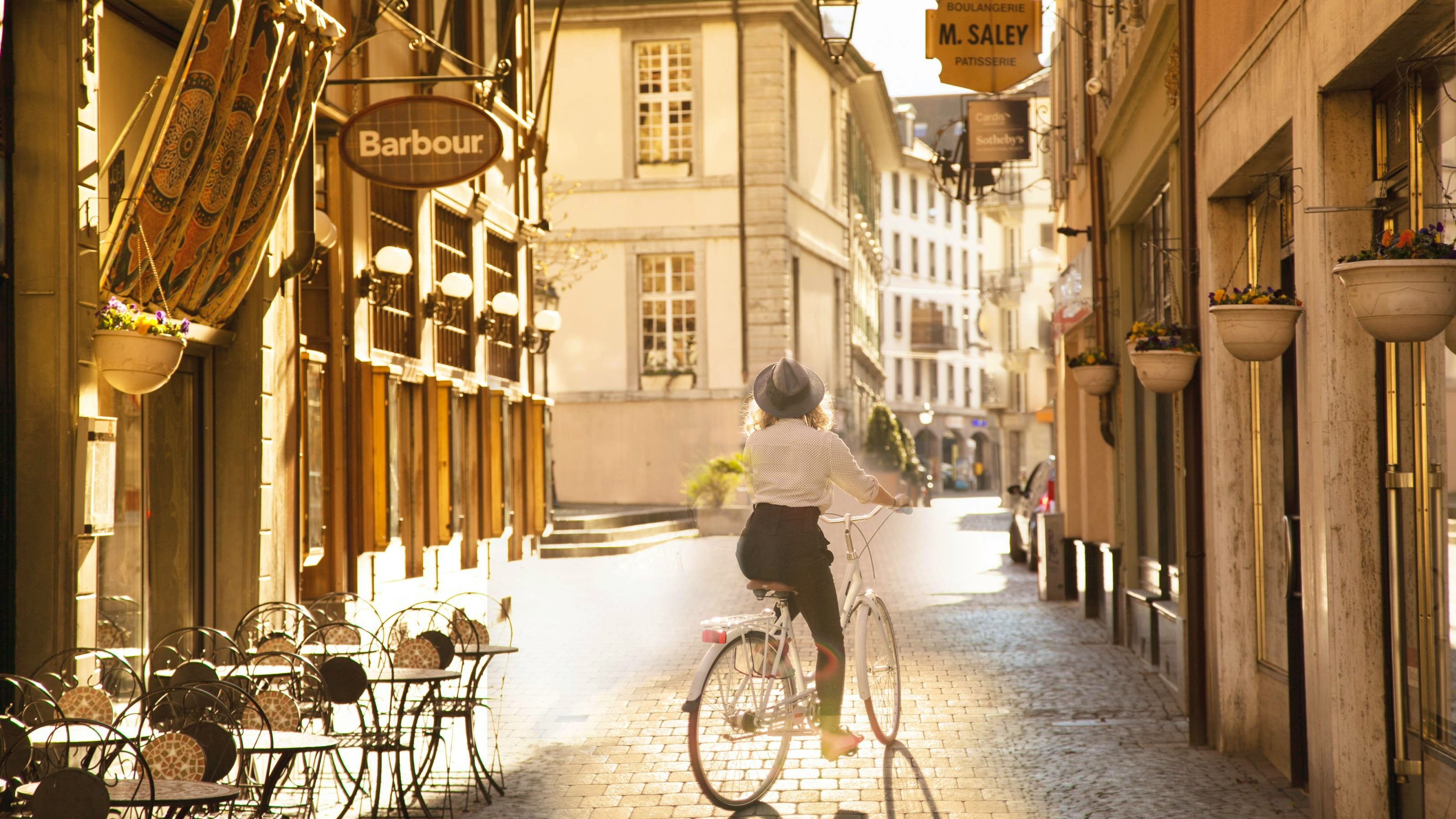 Someone cycling through a narrow alley in the old town centre.