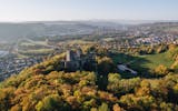 Castle ruins on a hill with a view of the town of Lörrach and Basel.