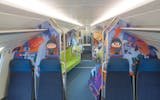 IC200 family coach – in front of the entrance to the children’s play area there is seating on both sides of the aisle. There is a green seating area on the left-hand side in the play area.